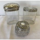 3 silver topped vanity jars.