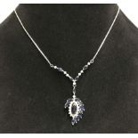 An 18ct white gold, blue & white sapphire pendant on 14ct gold chain.