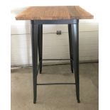 A modern bar style table with pressed steel frame and solid elm wooden top.