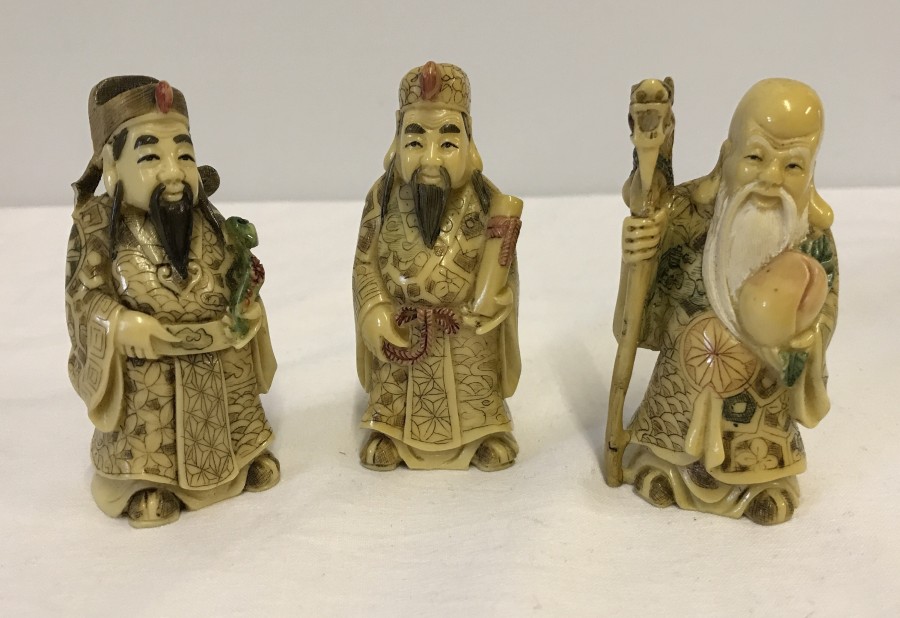 3 small Chinese figures.