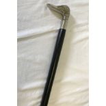 A black wooden walking stick with silver coloured ducks head handle.