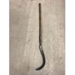 A vintage wooden handled scythe.