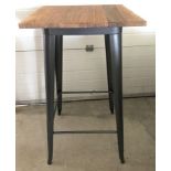 A modern wine bar style table with pressed steel frame and solid elm wooden top.