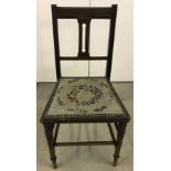A tapestry seated oak chair.