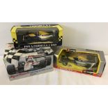 2 boxed Williams Formula 1 racing cars together with a F1 alarm clock.