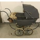 A 1950's Tri-ang grey dolls pram with original sun canopy.