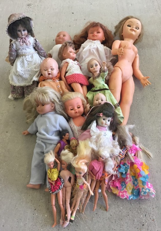 A quantity of vinyl, plastic and porcelain dolls.