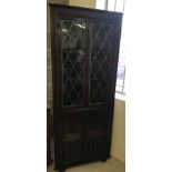 Modern dark wood corner unit with leaded glass doors.