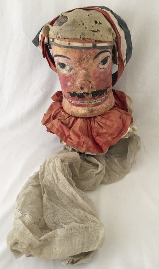 An antique fairground Aunt Sally head.