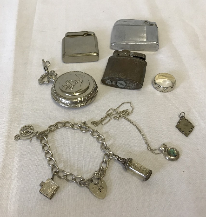 A small collection of silver jewellery and lighters.