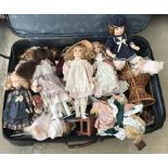 Approx 22 soft bodies porcelain dolls in traditional clothing.