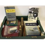 A box of assorted military related books and other items.