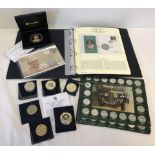 A collection of assorted commemorative coins, coin covers and medals.
