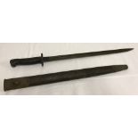 A 1907 British bayonet & leather scabbard.