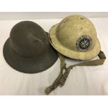 2 tin helmets. One marked RO & CO 9/41 with leather and fabric insert.