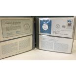 Folder of 4 United Nations silver proof medallic first day cover sets.