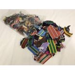 A bag of various medal ribbons of many different types and lengths.