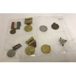 A collection of 8 George V and George VI coronation medals and badge.