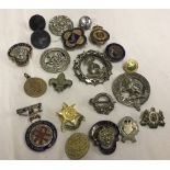 A quantity of assorted badges - some silver.