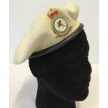 A cream felt beret with Royal Air Force Police Association badge.