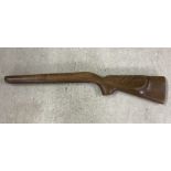 A wooden rifle stock.