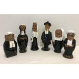 A collection of 6 pottery figurines of judges, lawyers and barristers.