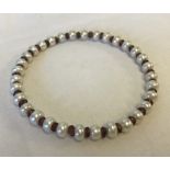 A freshwater pearl and garnet bangle.