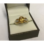 Hallmarked 9ct gold citrine and diamond dress ring.