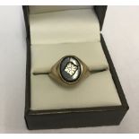 9ct gold gents signet ring with small central diamond set into oval onyx.