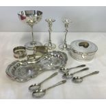 A small collection of silver plate items to include candle sticks and napkin rings.