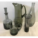 A collection of smoked glass pieces to include a Dartington Glass decanter.