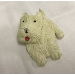 A vintage West Highland terrier plastic brooch with moveable head.