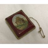 A 9ct gold mounted rectangular ceramic micro mosaic brooch with safety chain.