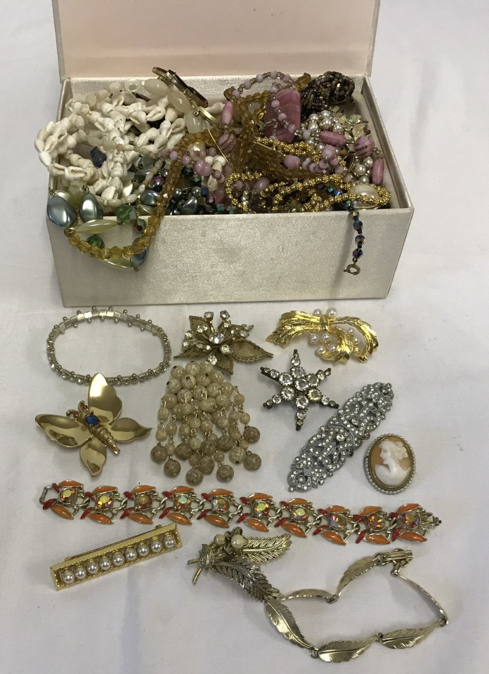 A box of good vintage costume jewellery including brooches, cufflinks and earrings.