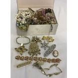 A box of good vintage costume jewellery including brooches, cufflinks and earrings.