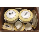 A box of Art Deco design Palissy dinner ware of cream, gold and yellow colouration.