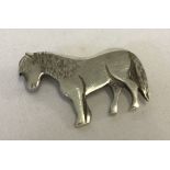 A hallmarked silver brooch in the shape of a horse.
