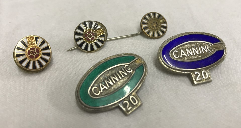 2 hallmarked silver badges with coloured enamel outers, marked Canning 20.