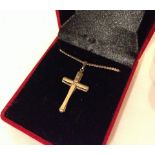 A 9ct gold cross on a 9ct chain.