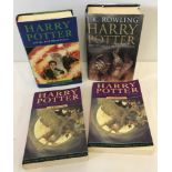 3 first edition Harry Potter books together with one other Harry potter book.