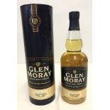 A bottle of Glen Moray single malt whisky in presentation tube.