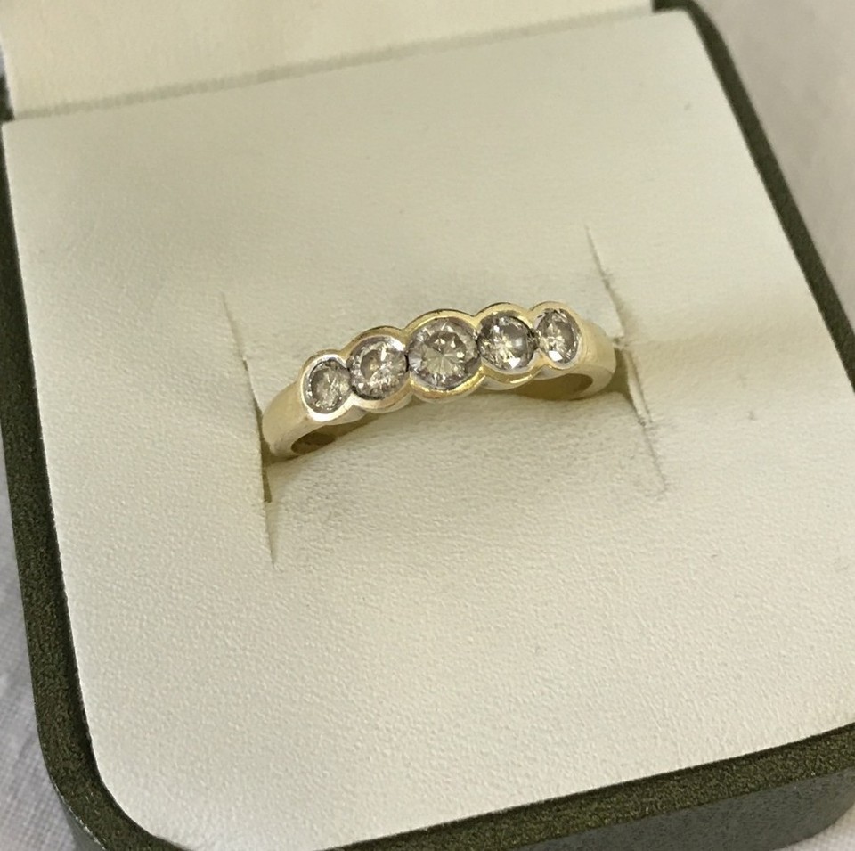 A 18ct gold 5 stone diamond eternity ring. Total diamond weight 1/2 carat.