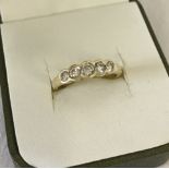 A 18ct gold 5 stone diamond eternity ring. Total diamond weight 1/2 carat.