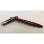 A Maroon and gold Parker Duofold 14k gold nib fountain pen.