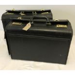 2 black flight bags with combination locks.