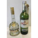 A 700ml bottle of Goldschlager cinnamon schnapps together with a litre bottle of Pernod.