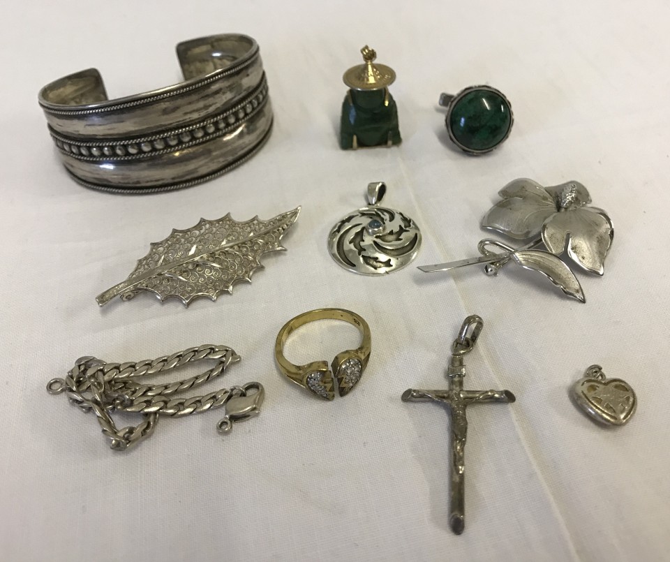 A small collection of silver and white metal jewellery together with a jade Buddha pendant.