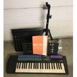 A Yamaha Portatone PSR-73 electronic keyboard with power adapter and instruction manual.