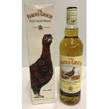 A boxed bottle of Famous Grouse Scotch whisky.