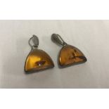 A pair of 925 silver and amber drop earrings.